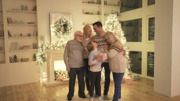 The happy family with a gift box standing near the christmas tree — Stock Footage Happy Family Gift Box Standing Christmas Tree Stock Video