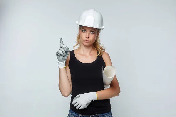 blonde girl. in a white safety helmet indicates empty space for text. construction concept