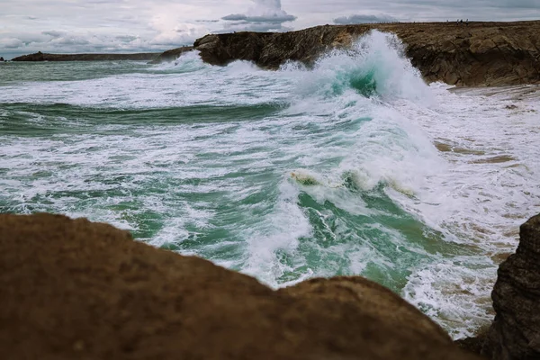 A rough ocean with waves crashing into the rocks. Bretagne, France