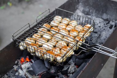 Kırmızı biberle tatlandırılmış, açık ateşte kızartılmış mantarların yakın çekimi.