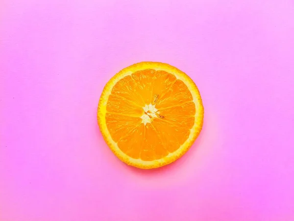 Slices of juicy orange on a bright pink background. — Stock Photo, Image