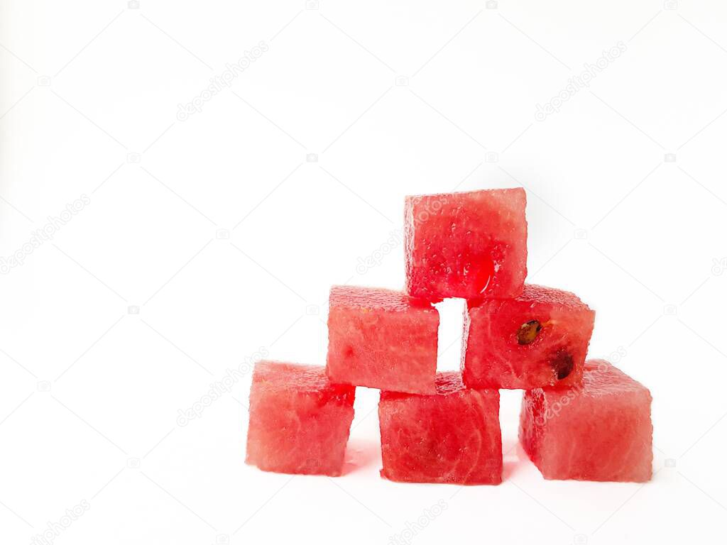 Bright ripe juicy red watermelon squares on a white background. Space for text.
