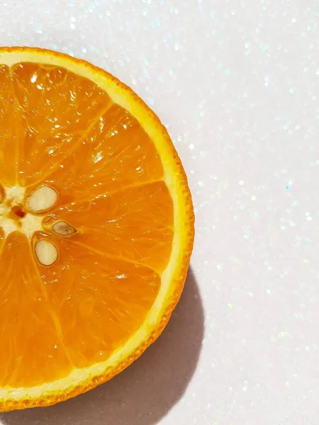 Bright juicy delicious orange on a white shiny background. Space for text. — Stock Photo, Image