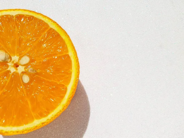 Bright juicy delicious orange on a white shiny background. Space for text. — Stock Photo, Image