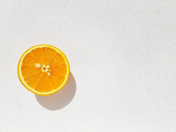 Bright juicy delicious orange on a white shiny background. Space for text. — Stock Photo, Image