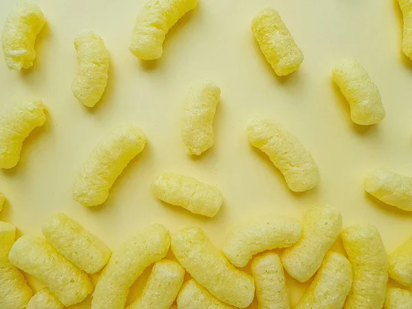 Желтые кукурузные палочки на желтом фоне . — стоковое фото
