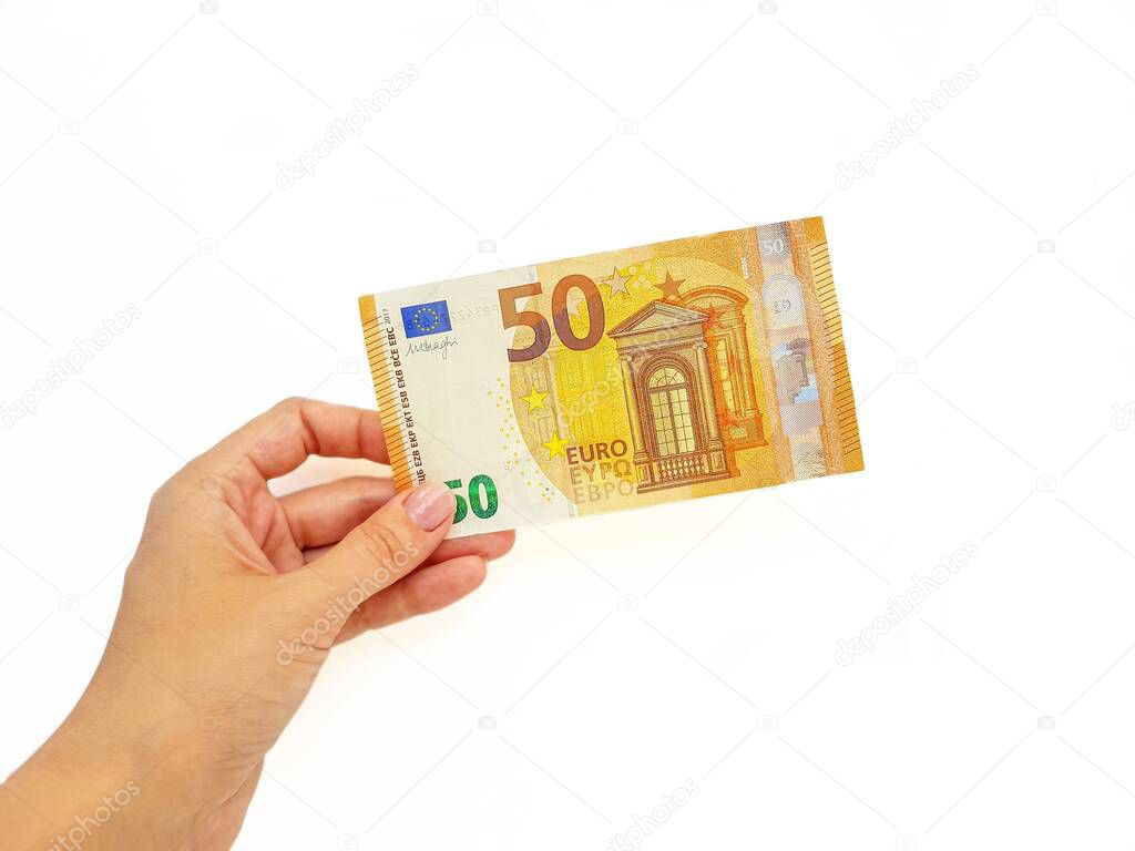 The womans hand stretches the paper money of the euro against a white background. Bribe. Loan repayment. Mortgage. Duty. Salary. Installment.