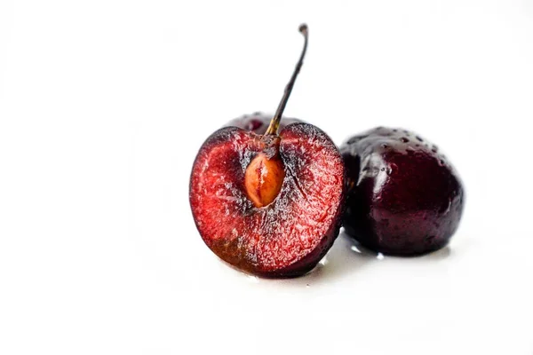 Bright juicy ripe cherry with drops of water on a white background. — Stock Photo, Image