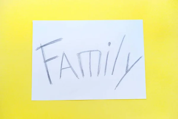 The text of the family on a white sheet of paper in a cage on a bright yellow background. Destruction and divorce. Step by step. — Stock Photo, Image