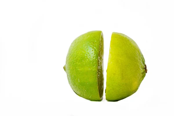 Bright juicy green lime on a white background cut in half. — Stock Photo, Image