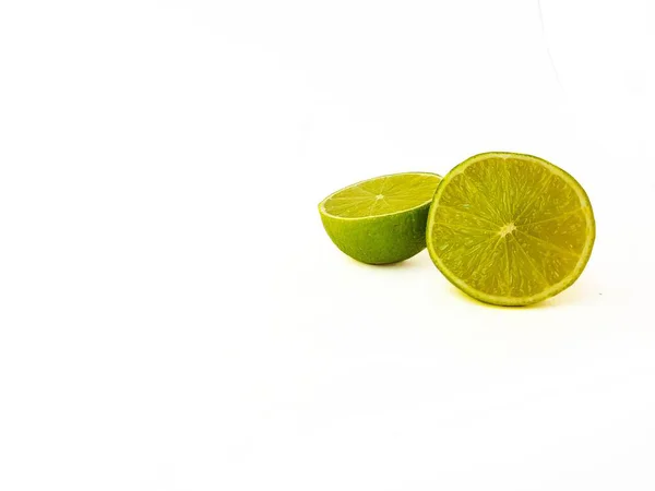 Bright juicy green lime on a white background cut in half. — Stock Photo, Image