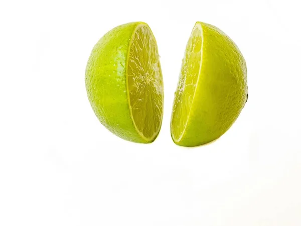 Bright juicy sour lime on a white background cut in half. — Stock Photo, Image