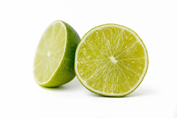 Bright juicy sour lime on a white background cut in half. — Stock Photo, Image