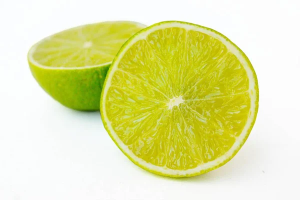 Bright juicy sour lime on a white background cut in half. — Stock Photo, Image