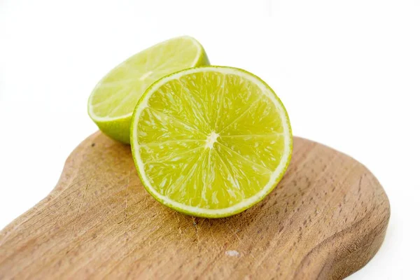 Bright juicy sour lime on a white background cut in half. — Stock Photo, Image