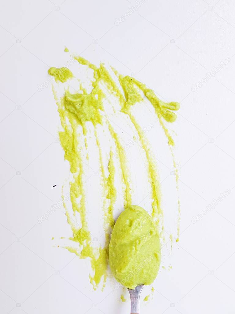 Spoon the wasabi on a stained surface on a white background.