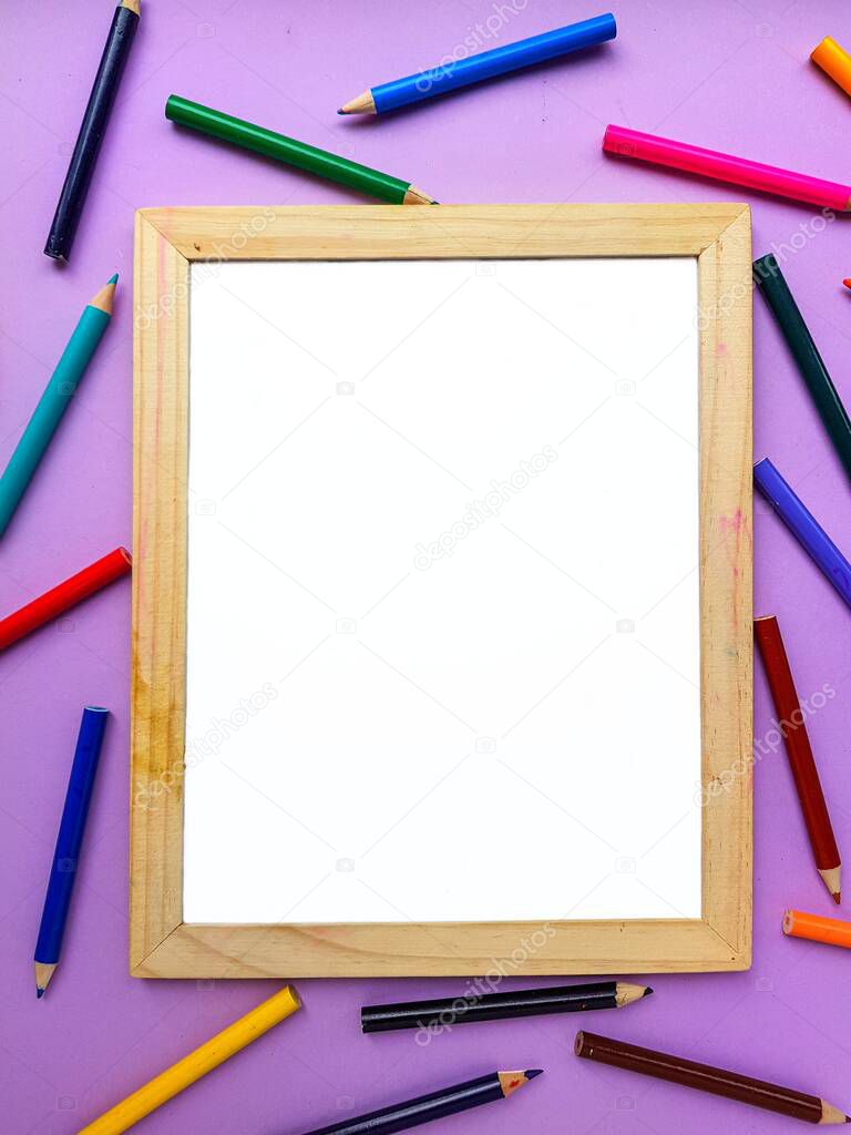Empty clean white sheet for the buyers text on the purple background and school supplies, pencils. Back to school.