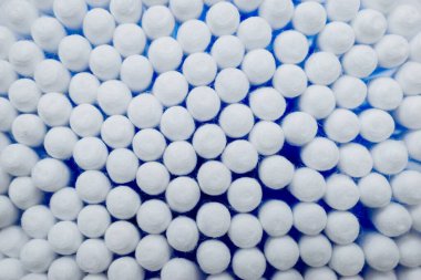 Pamuk, beyaz arka plana mavi kulak plastiği yapıştırır. Kişisel hijyen ve bakım. Kozmetoloji ve tıp.