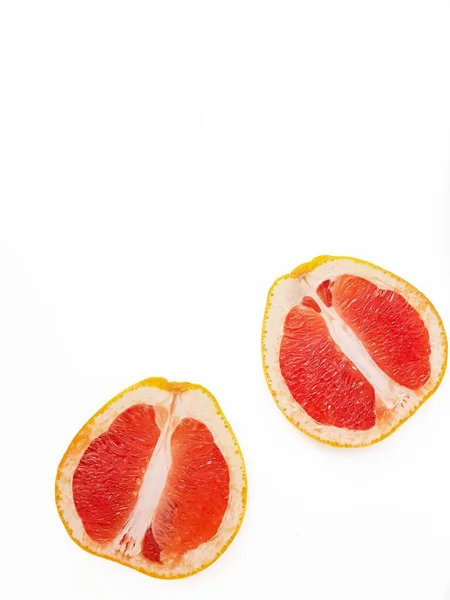 Red ripe juicy grapefruit in a cut on a white background view from above. The concept of diet and healthy eating. A place for text. — Stock Photo, Image