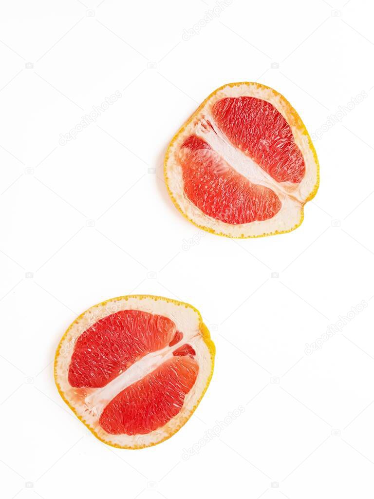 Red ripe juicy grapefruit in a cut on a white background view from above. The concept of diet and healthy eating. A place for text. 