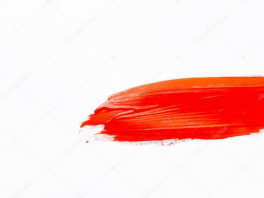 A smear of red paint on a white background. A place for text.