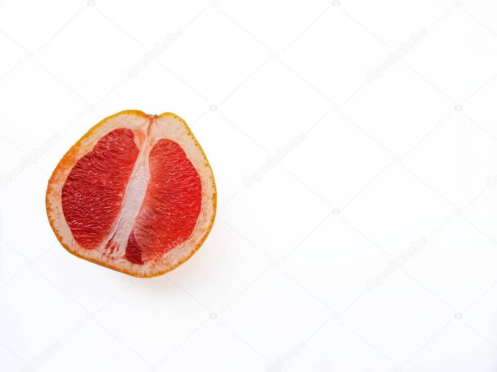 Red ripe juicy grapefruit in a cut on a white background view from above. The concept of diet and healthy eating. A place for text. 