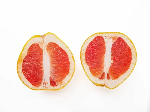 Red ripe juicy grapefruit in a cut on a white background. The concept of diet and healthy eating. A place for text. — Stock Photo, Image