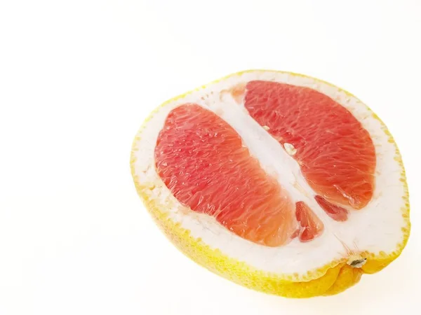 Red ripe juicy grapefruit in a cut on a white background. The concept of diet and healthy eating. A place for text. — Stock Photo, Image