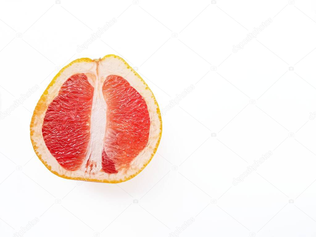 Red ripe juicy grapefruit in a cut on a white background. The concept of diet and healthy eating. A place for text. 