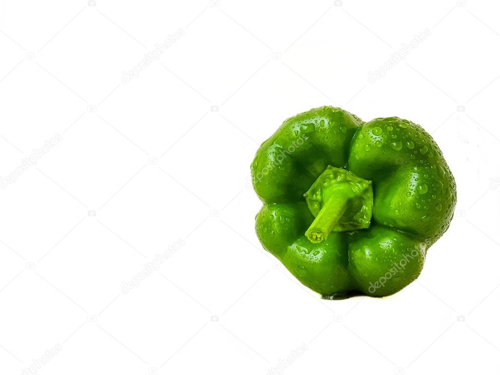 Green bell pepper on a white background. The concept of a healthy diet.