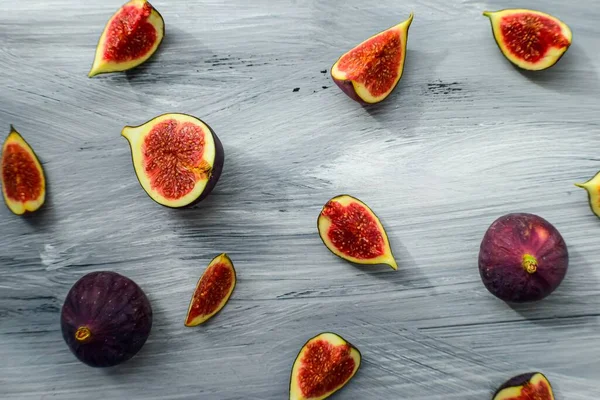 Figues mûres lumineuses sur la surface en bois à l'arrière d'un fond sombre. — Photo