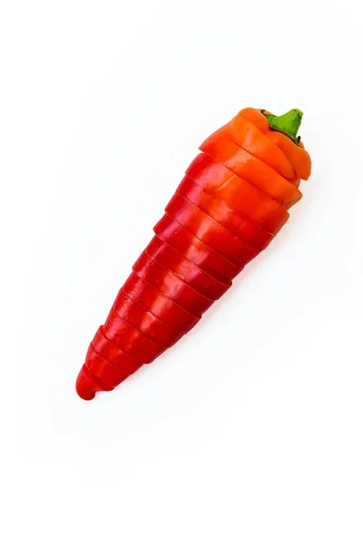 Red fresh pepper cut into equal parts of the ring on a white background. — Stock Photo, Image