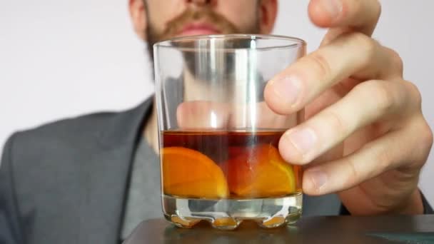 Stilig Skäggig Man Tar Ett Glas Whisky Med Citron Och — Stockvideo