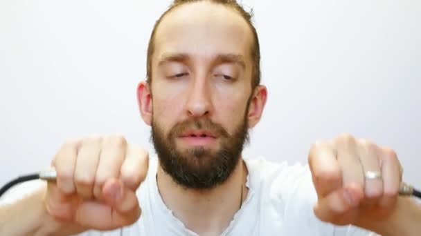 Cute Bearded Man Shocked Connects Two Wires — Stock Video