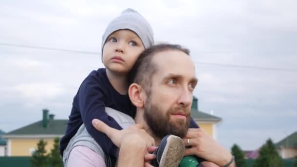 Portrait Young Bearded Man His Little Son Sitting Shoulders Outdoors — Stock Video