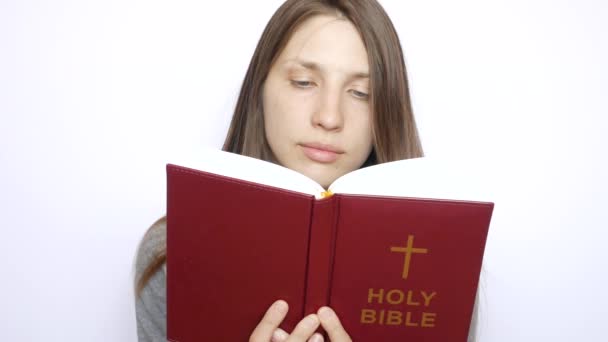 Young Beautiful Woman Reads Holy Bible Carefully — Stock Video