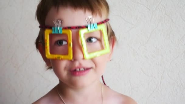Little Boy Has Fun Handmade Toy Glasses Face — Stock Video