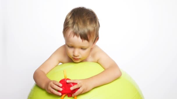 Happy Little Boy Lies Big Soft Ball Playing Colorful Toy — Stock Video