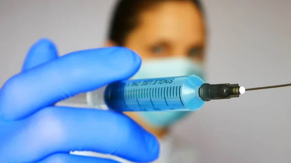 Hand Young Nurse Protective Mask Gloves Holding Syringe Blue Liquid — Stock Photo, Image