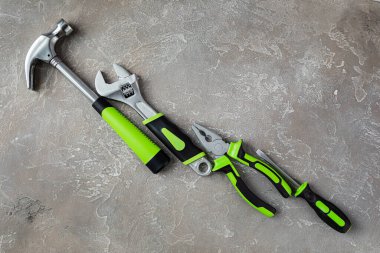 Çeşitli inşaat aletleri. Ev onarımı için aletler. İnşaat alanında çalışıyorum. Gri, pürüzlü beton arka planda. Düz yatıyordu.