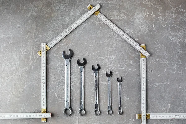 A set of various construction tools. Tools for home repair. Work on a construction site. On a gray, rough concrete background. Flat lay.