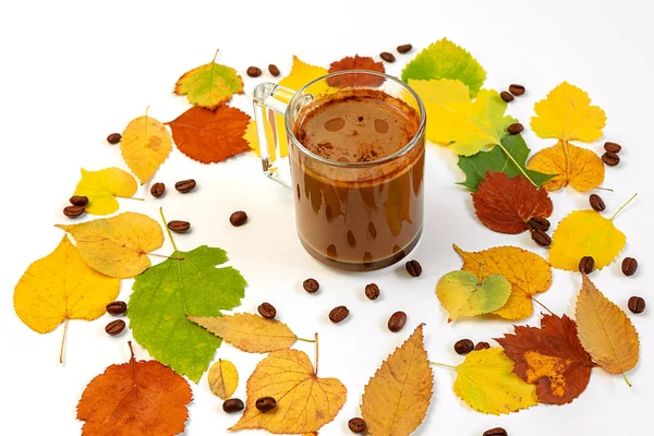 Autumn flat composition coffee Cup with a wreath of brightly colored dry leaves and coffee beans lying on a white background. Creative autumn, thanksgiving, Halloween concept. Top view, copy space