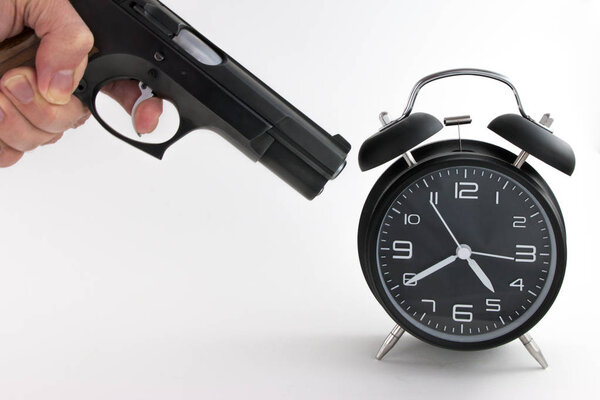 Vintage Alarm Clock with gun on white background