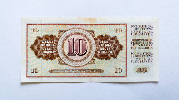 Paper banknote isolated on white background, reverse of ten dinars of the Socialist Federal Republic of Yugoslavia.