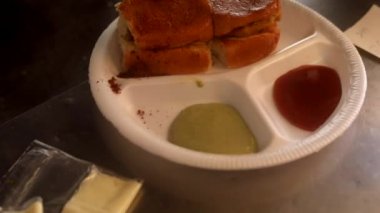 Kızartma tavasında Hint sokak vada pav yeşil turşu, kırmızı domates sosu ve masala ile servis edilir..