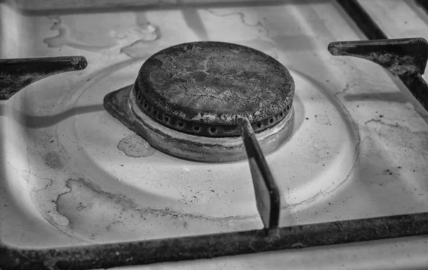 old dirty rusty switch off gas stove burner. black and white