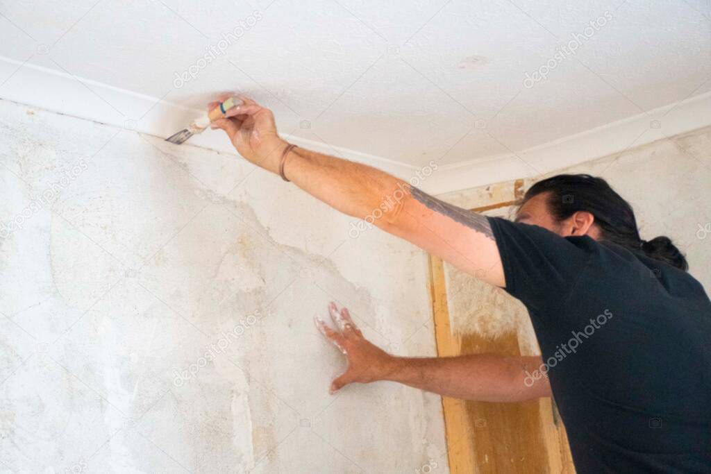 Man renovation walls plastering   cracks  in wall interier 