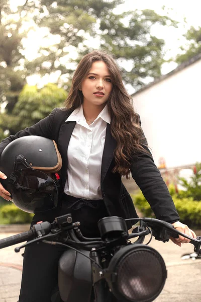 woman with helmet and motorcycle being businesswoman
