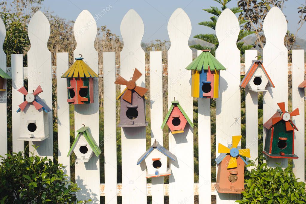 Collection of colorful wooden birdhouses.