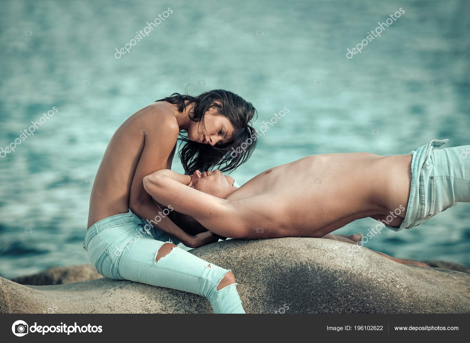 Sensual nude attractive couple on passionate faces. Couple in love kissing  on seafront. Happy family spend time together, hug and kiss, sea surface  background. Honeymoon concept Stock Photo by ©Tverdohlib.com 196102622